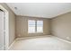 Cozy bedroom with soft carpet, natural light from two windows, and a view of the serene surroundings at 560 Tracy Ln, Brownsburg, IN 46112
