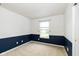 Bedroom with neutral carpet, window, and baseboard detail at 560 Tracy Ln, Brownsburg, IN 46112