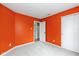 Bedroom featuring neutral carpet and bright orange walls at 560 Tracy Ln, Brownsburg, IN 46112