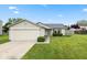 Charming single-story home featuring an attached two-car garage and a well-maintained lawn with manicured shrubs at 560 Tracy Ln, Brownsburg, IN 46112