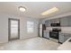 Bright kitchen with stainless steel appliances, light gray cabinets, a skylight, and easy access to outdoor patio at 560 Tracy Ln, Brownsburg, IN 46112