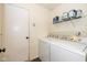 Laundry room with washer, dryer, and shelving at 560 Tracy Ln, Brownsburg, IN 46112