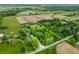 Aerial view of property with a pond, surrounded by a verdant landscape, enclosed by property lines at 5730 S 50 W, Trafalgar, IN 46181