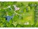 Aerial view featuring the home and picturesque pond, all surrounded by lush greenery at 5730 S 50 W, Trafalgar, IN 46181