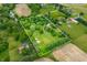 Aerial view shows the entire property featuring a home and pond, defined by boundary lines at 5730 S 50 W, Trafalgar, IN 46181
