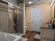 Bathroom featuring a walk-in shower, soaking tub, and single vanity with a brown countertop at 5730 S 50 W, Trafalgar, IN 46181