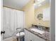 Bathroom features a shower-tub combo with updated vanity and granite countertop at 5730 S 50 W, Trafalgar, IN 46181