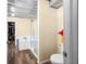 Bright bathroom features a glass shower, soaking tub, metal ceiling, and wood-look floors at 5730 S 50 W, Trafalgar, IN 46181