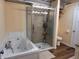 Bathroom featuring a walk-in shower, soaking tub, and toilet with a unique modern metallic ceiling at 5730 S 50 W, Trafalgar, IN 46181