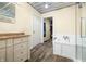 Bright bathroom features white vanity, shower, soaking tub, metal ceiling, and wood-look floors at 5730 S 50 W, Trafalgar, IN 46181