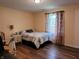 Bedroom featuring hardwood floors, a quaint desk, and a comfy bed at 5730 S 50 W, Trafalgar, IN 46181