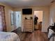 Bedroom view features wood floors, a dresser, and access to the bathroom and closet at 5730 S 50 W, Trafalgar, IN 46181