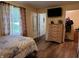 Bedroom view features wood floors, a dresser, and a view to the outdoors at 5730 S 50 W, Trafalgar, IN 46181