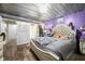 Bedroom features decorative lighting, laminate floors, and an adjoining bathroom with shower-tub combo at 5730 S 50 W, Trafalgar, IN 46181