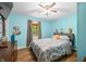Comfortable bedroom featuring hardwood floors, ceiling fan, and large bed with neutral tones at 5730 S 50 W, Trafalgar, IN 46181
