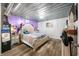 Bright bedroom featuring modern chandelier lighting, laminate floors, and a large comfortable bed at 5730 S 50 W, Trafalgar, IN 46181