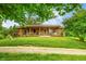 Exterior view of a charming single-story home with a covered porch and verdant lawn at 5730 S 50 W, Trafalgar, IN 46181
