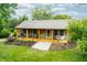 Inviting exterior featuring a lovely front porch, stone accents, and well-maintained landscaping at 5730 S 50 W, Trafalgar, IN 46181