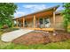Inviting exterior showcasing a covered porch with outdoor seating and professionally landscaped yard at 5730 S 50 W, Trafalgar, IN 46181