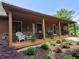 Charming front porch with rocking chairs and a view of the beautifully landscaped front yard at 5730 S 50 W, Trafalgar, IN 46181