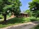 Home with a covered porch overlooking a serene and green landscape, with a gravel path at 5730 S 50 W, Trafalgar, IN 46181