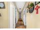 The hallway features a hardwood floor and white doors and leads to other rooms in the home at 5730 S 50 W, Trafalgar, IN 46181