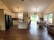 Open kitchen featuring white cabinetry, a large island, and a view of the dining and living areas at 5730 S 50 W, Trafalgar, IN 46181