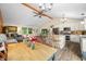 Open-concept kitchen with an island, stainless appliances, bright lighting and seamlessly flowing into the dining and living area at 5730 S 50 W, Trafalgar, IN 46181