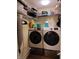Modern laundry room with front-loading Samsung washer and dryer and wire shelving for ample storage at 5730 S 50 W, Trafalgar, IN 46181