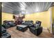 Living room features multiple leather recliners, laminate flooring, and decorative lighting at 5730 S 50 W, Trafalgar, IN 46181