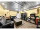 Large living room area with laminate flooring, multiple seating areas, and modern lighting fixtures at 5730 S 50 W, Trafalgar, IN 46181