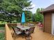 Outdoor patio with a table, chairs, and umbrella, perfect for outdoor dining and relaxation at 5730 S 50 W, Trafalgar, IN 46181