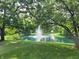 Scenic pond with a fountain surrounded by lush greenery and two yellow chairs at 5730 S 50 W, Trafalgar, IN 46181
