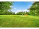 Large green field of grass with shed in background at 5730 S 50 W, Trafalgar, IN 46181