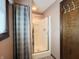 Bathroom showcasing a glass-enclosed shower, linen closet, window, and tile flooring at 5730 Teresa Dr, Alexandria, IN 46001