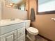 Bright bathroom featuring a white vanity with drawers, standard toilet, and window with natural light at 5730 Teresa Dr, Alexandria, IN 46001