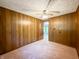 Bedroom with neutral carpet, wood paneled walls and a ceiling fan at 5730 Teresa Dr, Alexandria, IN 46001