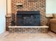 Close-up of a brick fireplace with a black insert and tiled hearth, offering a warm focal point at 5730 Teresa Dr, Alexandria, IN 46001