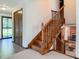 Inviting home foyer with wooden stairs and views into the living room at 5730 Teresa Dr, Alexandria, IN 46001