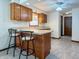 Eat-in kitchen featuring classic oak cabinetry, light countertops, and barstool seating at 5730 Teresa Dr, Alexandria, IN 46001