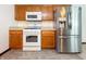 Well-equipped kitchen with stainless steel refrigerator, gas range, and microwave at 5730 Teresa Dr, Alexandria, IN 46001