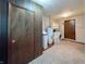 Spacious laundry room includes washer, dryer, water softener, and storage, with carpeted floors at 5730 Teresa Dr, Alexandria, IN 46001