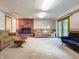 Finished basement with brick fireplace and hearth, recessed lighting, tile accent, plush carpet, and access to the backyard at 5730 Teresa Dr, Alexandria, IN 46001