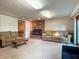 Basement features a brick fireplace, carpeted floors, and comfortable seating, perfect for a relaxing space at 5730 Teresa Dr, Alexandria, IN 46001