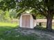 Outdoor shed nestled amongst the trees with adjacent fencing at 5730 Teresa Dr, Alexandria, IN 46001