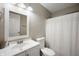 Simple bathroom with white vanity, mirror, lighting and a shower and tub combination with a shower curtain at 5873 N Victoria Dr, Indianapolis, IN 46228