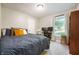 Well-lit bedroom with modern decor, featuring a nice window view, and a dedicated workspace at 5873 N Victoria Dr, Indianapolis, IN 46228