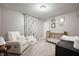 Inviting Bedroom with a cozy recliner, gold crib, and stylish décor, creating a calm and relaxing space at 5873 N Victoria Dr, Indianapolis, IN 46228