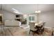 Open concept dining area with vaulted ceilings, skylight, and seamless flow to the living room at 5873 N Victoria Dr, Indianapolis, IN 46228
