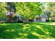 Well-manicured lawn and landscaping complement this charming single-story brick home at 5873 N Victoria Dr, Indianapolis, IN 46228